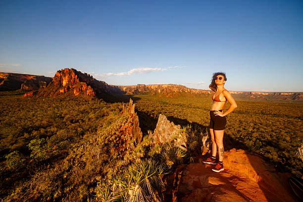 woman poses for portrait after mountain range adventure