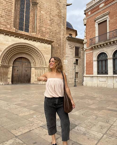 istock Happy woman in old town 2240626677