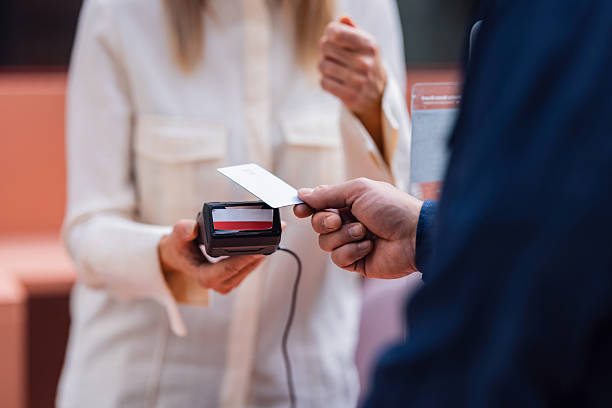 istock Customer Pays With Card At Counter While Cashier Accepts Payment With Card Reader 2240629324