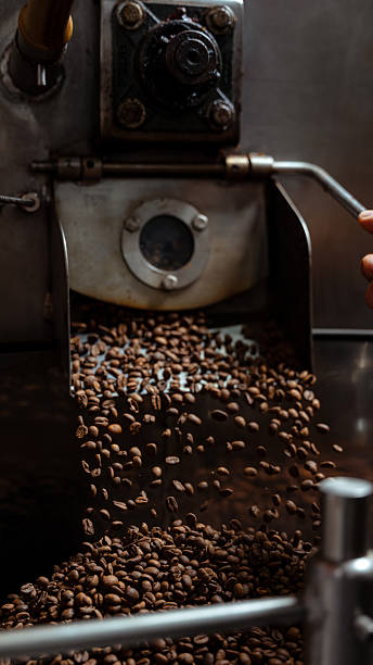 istock Coffee beans roasting in industrial roaster machine 2240631761