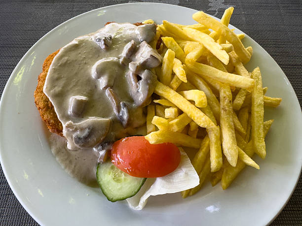 istock Schnitzel with mushroom sauce and fries 2240632251
