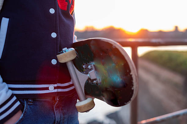Young man is skating with skateboard in public park at sunset.Istanbul - Turkey.