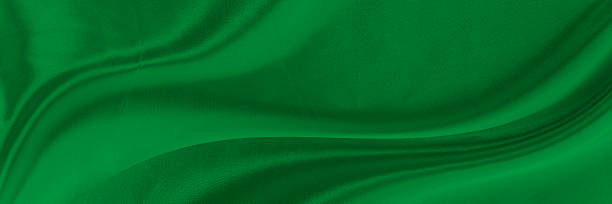 istock Black green satin dark fabric texture luxurious shiny that is abstract silk cloth background with patterns soft waves blur beautiful. 2240633708