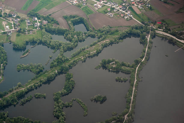 Serene river landscape. Aerial photo suitable for illustrating rural geography, environmental studies, or land use planning.