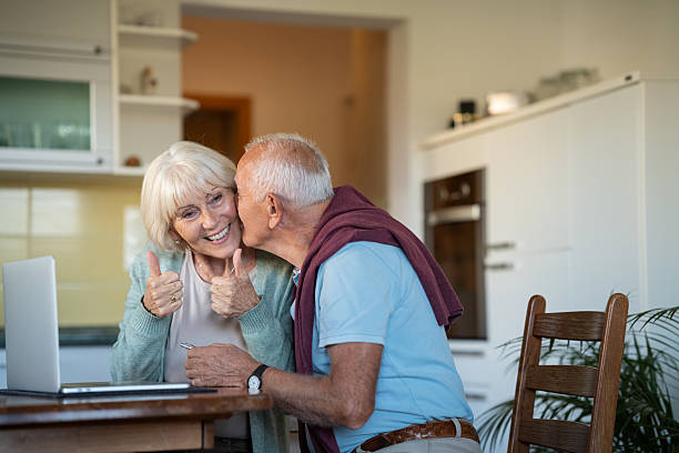 istock Elderly Couple Checking Travel Destination On Laptop 2240634913