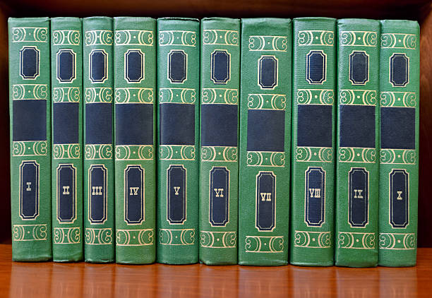 A close-up view of a row of blue hardcover books neatly lined up on a shelf in a library or bookstore. Perfect for themes related to reading, education, or organization.
