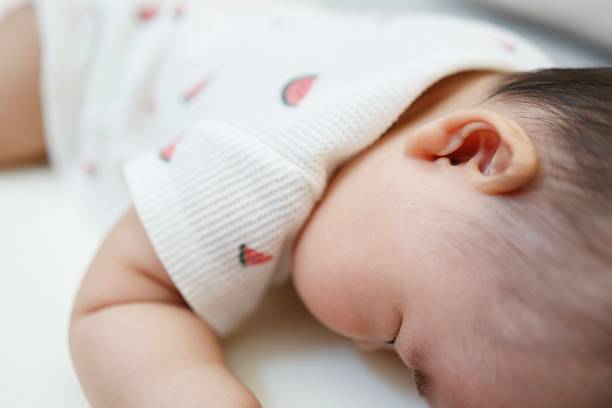 istock Close-up of a baby's face sleeping on his stomach 2240638475