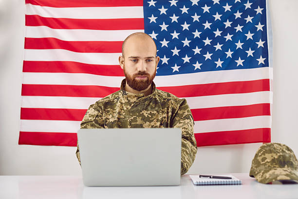 istock American military student sitting at his desk and working on his laptop computer 2240643578
