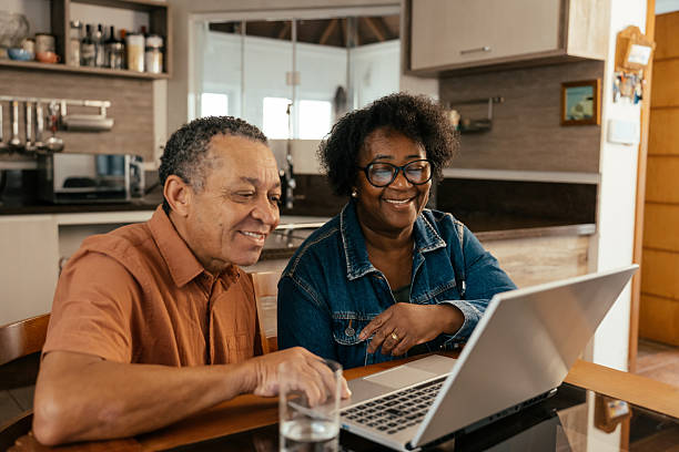 istock Elderly couple looking at tickets and accommodation on their laptop 2240648237