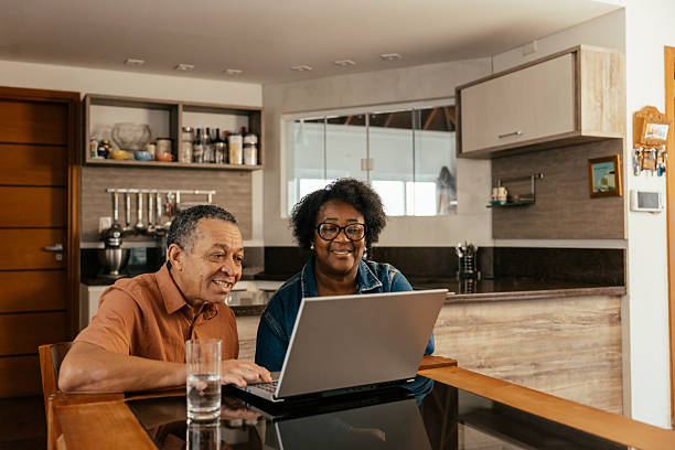 istock Elderly couple looking at tickets and accommodation on their laptop 2240648239