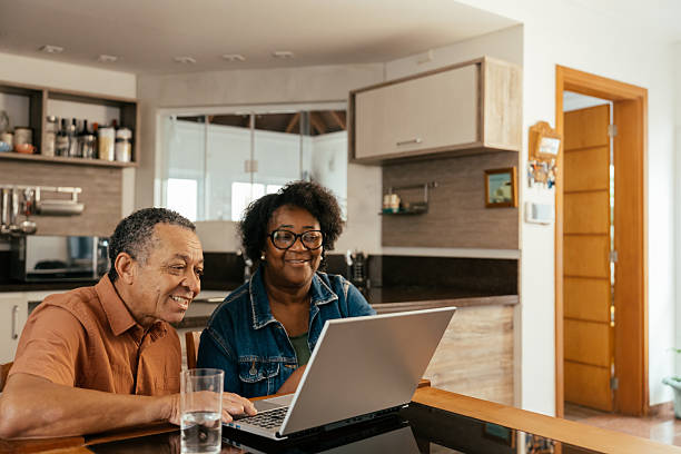 istock Elderly couple looking at tickets and accommodation on their laptop 2240648240