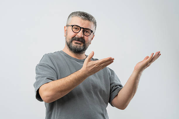 Young men gesturing sign language on isolated background