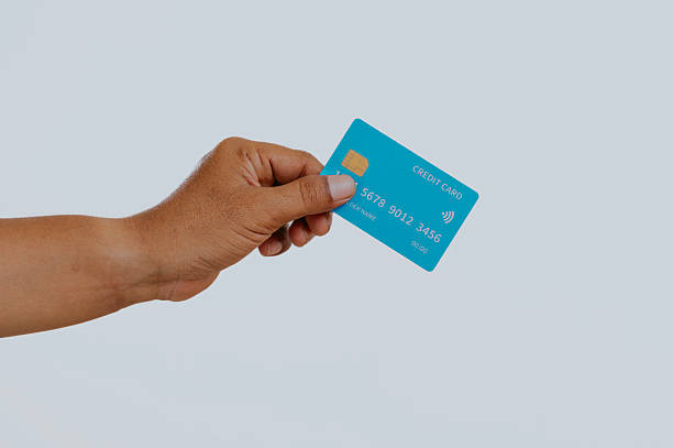 istock Hand holding a credit card. 2240648853
