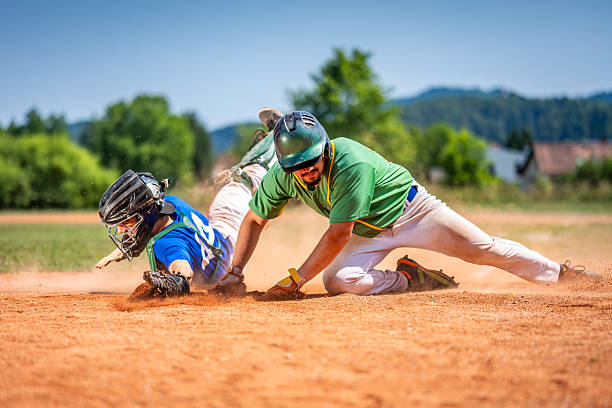 istock Baseball Player Sliding Headfirst at Dusty Base, Catcher Attempting Tag 2240650195
