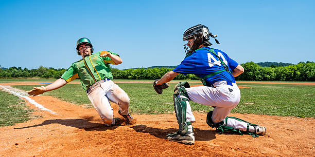 Baseball Runner Slides into Home Plate, Catcher Number 41 Prepares to Tag