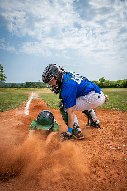 istock Baseball Player Tags Out Sliding Runner in Action 2240650229
