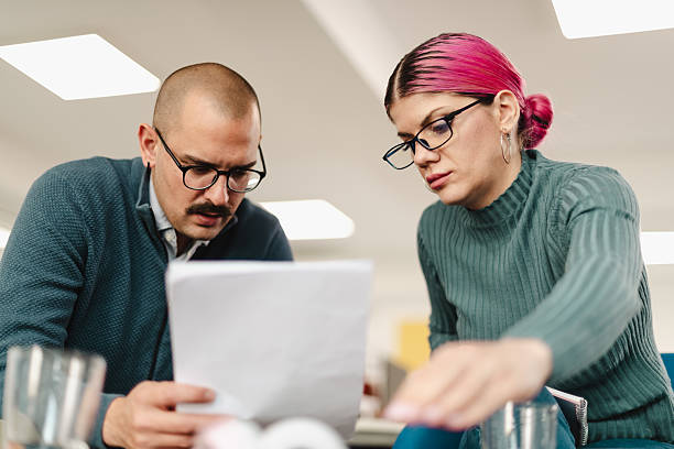 istock Businesspeople collaborating on a project in a modern office space during daytime 2240650580