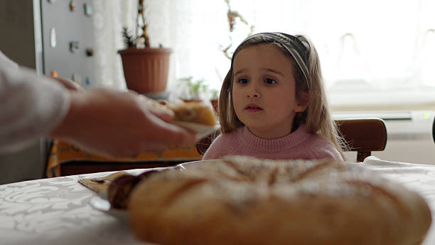 Poor Child homeless, beggar kid holds a pieces of black bread, war concept, poverty, crisis. Selective focus.Close-up.