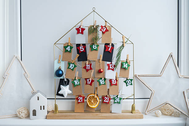istock Number on craft paper notes with tasks before Christmas holidays. Female making kraft paper for handmade advent calendar Made with your own hands step by step DIY 2240670957