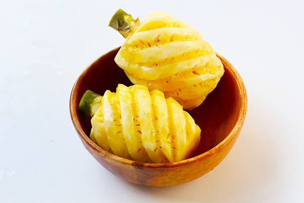 Freshly peeled pineapples with spiral cuts