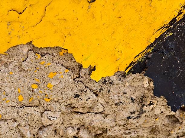 istock Stone texture aged black yellow -colored paint on concrete. 2240678090