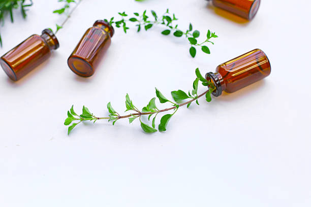 istock A small amber glass bottle with a green herb sprig placed inside. 2240678721