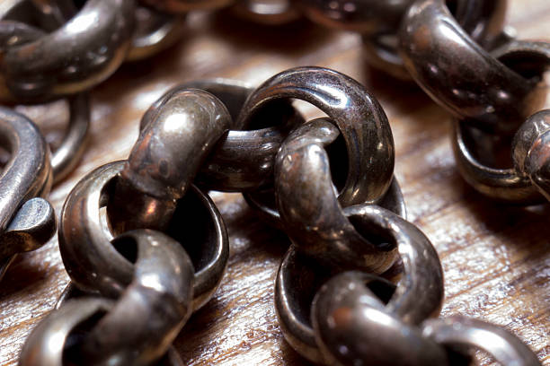an old, tarnished silver metal chain with round links. close-up