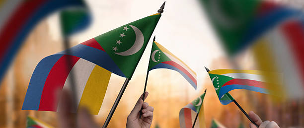 istock Comoros flags in their hands on a blurred urban background 2240678929