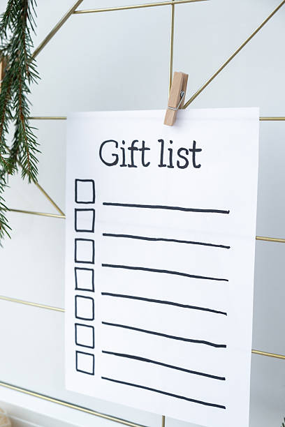 Preparation for winter holidays. GIFT LIST text on paper note. Celebration gifts and presents preparing Natural zero waste homemade Christmas decor. Happy new year