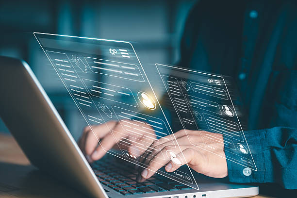 istock Generative AI chat interface concept. Close-up of hands typing on a laptop with virtual screens displaying user profiles and artificial intelligence conversations, representing future communication. 2240681949