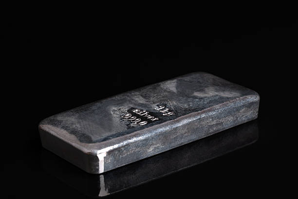istock Silver bar on a glass plate, against black background 2240682849