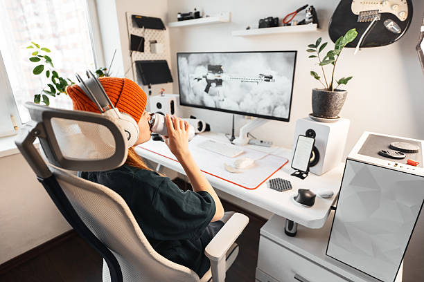 istock Side view of gamer interacting with a dynamic gaming environment. High-fidelity display, crisp audio, and responsive controls combine for fully immersive gaming experience. Girl drinks energy drink 2240684715