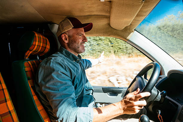 istock Man driving van on rural road. 2240684718