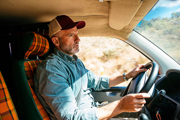 istock Man driving van on rural road. 2240684723