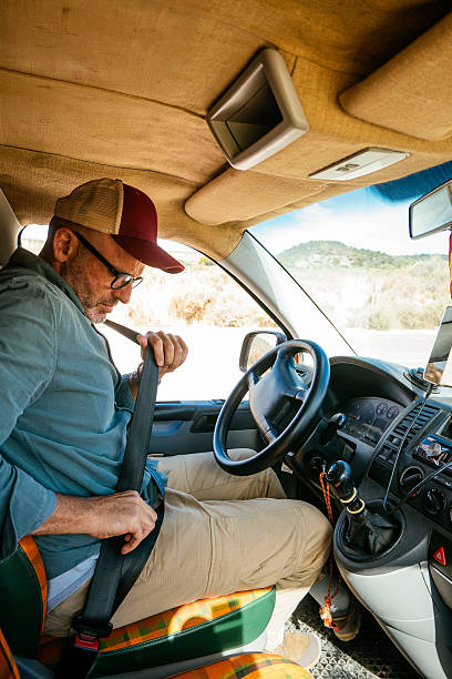 istock Man fastening seatbelt before starting road trip. 2240684734