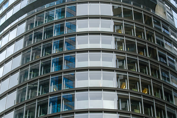 Close-up on the windows of a curved office building.