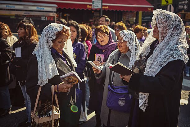 New York City, USA - October 24, 2010 : Religious followers praying together during their participation in a procession honoring \