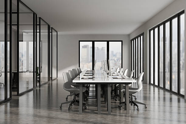 istock Modern 3D office interior with white desks, computers, and panoramic city skyline in soft natural light. 2240689498