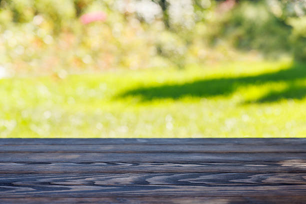 Wooden table with sunny bokeh background and copy space for product display