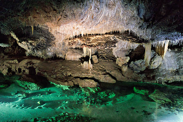 istock Stalactites and stalagmites with underground river in a cave 2240691792