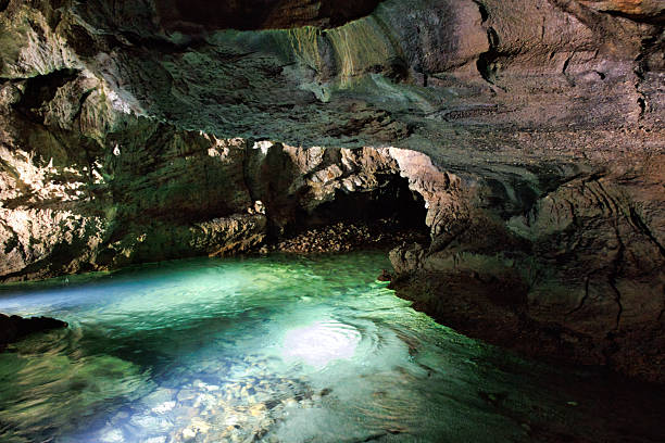 istock Stalactites and stalagmites with underground river in a cave 2240691795