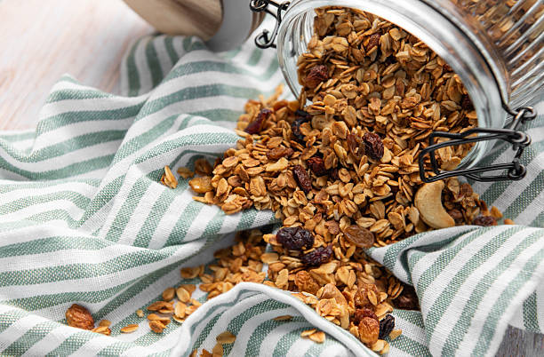 istock Granola pouring from jar on striped cloth 2240691859