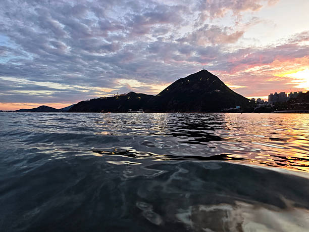 Idyllic sunset on Deep Water Bay beach. The bay is located on the southern shore of Hong Kong Island in Hong Kong. The bay is surrounded by Shouson Hill, Brick Hill, Violet Hill and Middle Island.