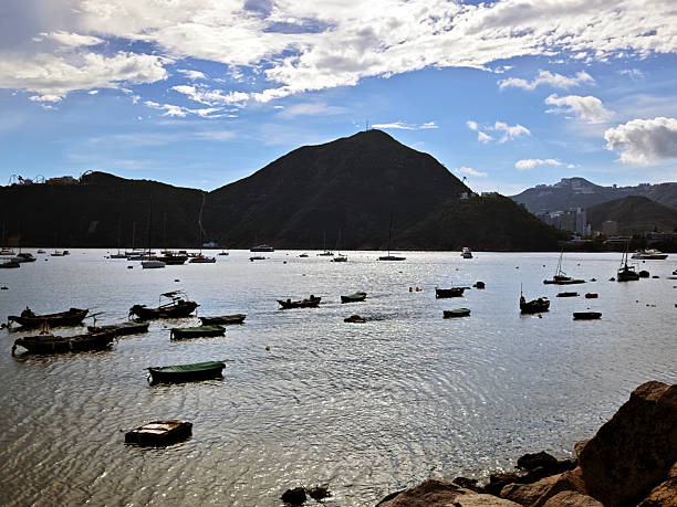 Boats moored on Deep Water Bay. The bay is located on the southern shore of Hong Kong Island in Hong Kong. The bay is surrounded by Shouson Hill, Brick Hill, Violet Hill and Middle Island.