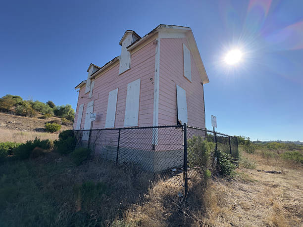 istock East Side View of Boarded-Up Pink House 2240696264