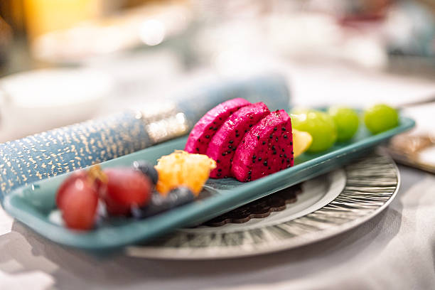 Assorted sliced fruits served on a plate at restaurant table