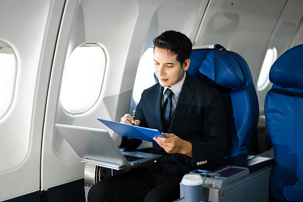 istock Confident businessman making a phone call in first class, blending luxury air travel with business, technology, and global networking opportunities. 2240699294