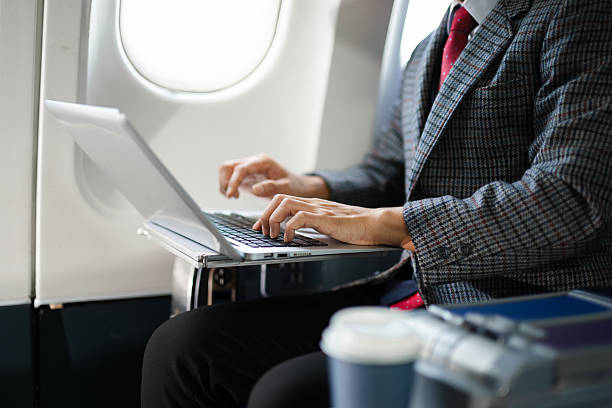 istock Confident businessman using a laptop in first class, blending productivity, luxury travel, and a modern digital lifestyle for business success. 2240699331