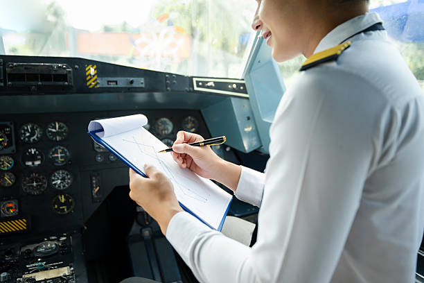 Professional airline pilot in uniform inspecting cockpit control panels during safety checks, ideal for aviation, travel, and airline safety themes.