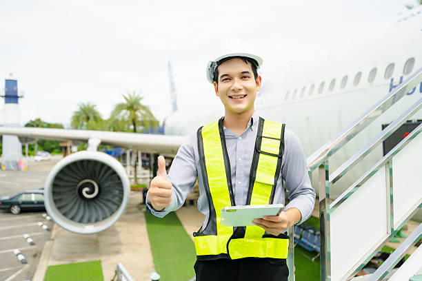 istock Aviation engineer inspects airplane for safety compliance. Professional aerospace technician at work in airport maintenance 2240699414